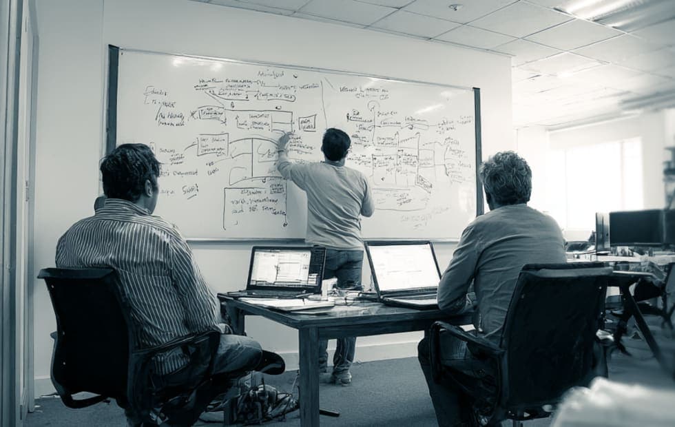 A startup security planning meeting around a shared table.